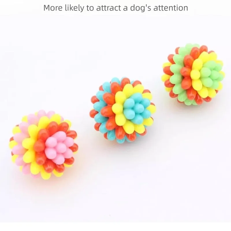 Multicolour durable rubber dog teething ball in red yellow and teal for dental cleaning and interactive play