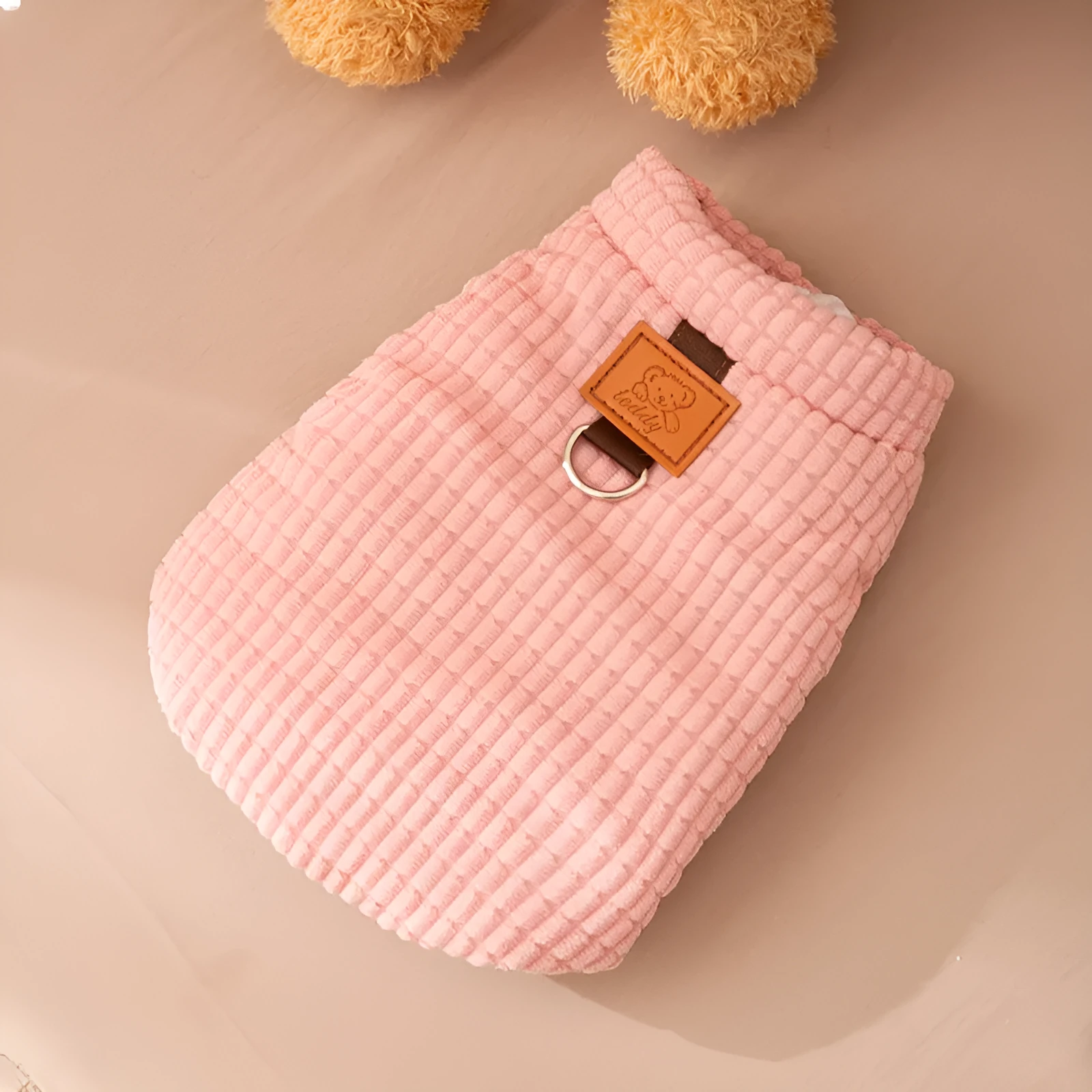 Pink corduroy dog vest with metal leash ring, cotton lining, and bear emblem tag, for small and medium dogs