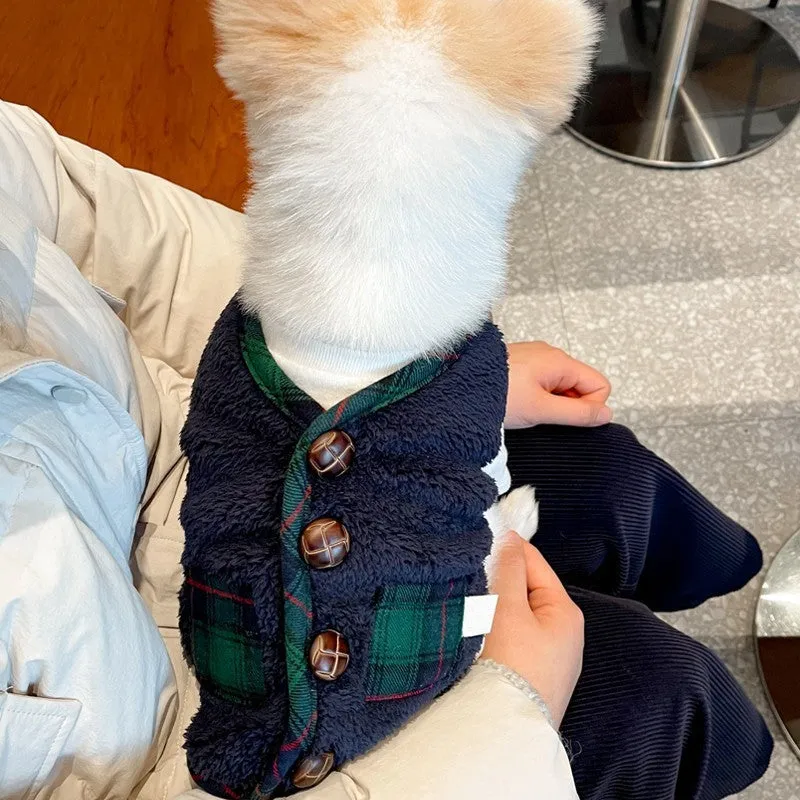 Red and navy blue checkered pet fleece jacket with Sherpa lining and snowman accent on a small dog