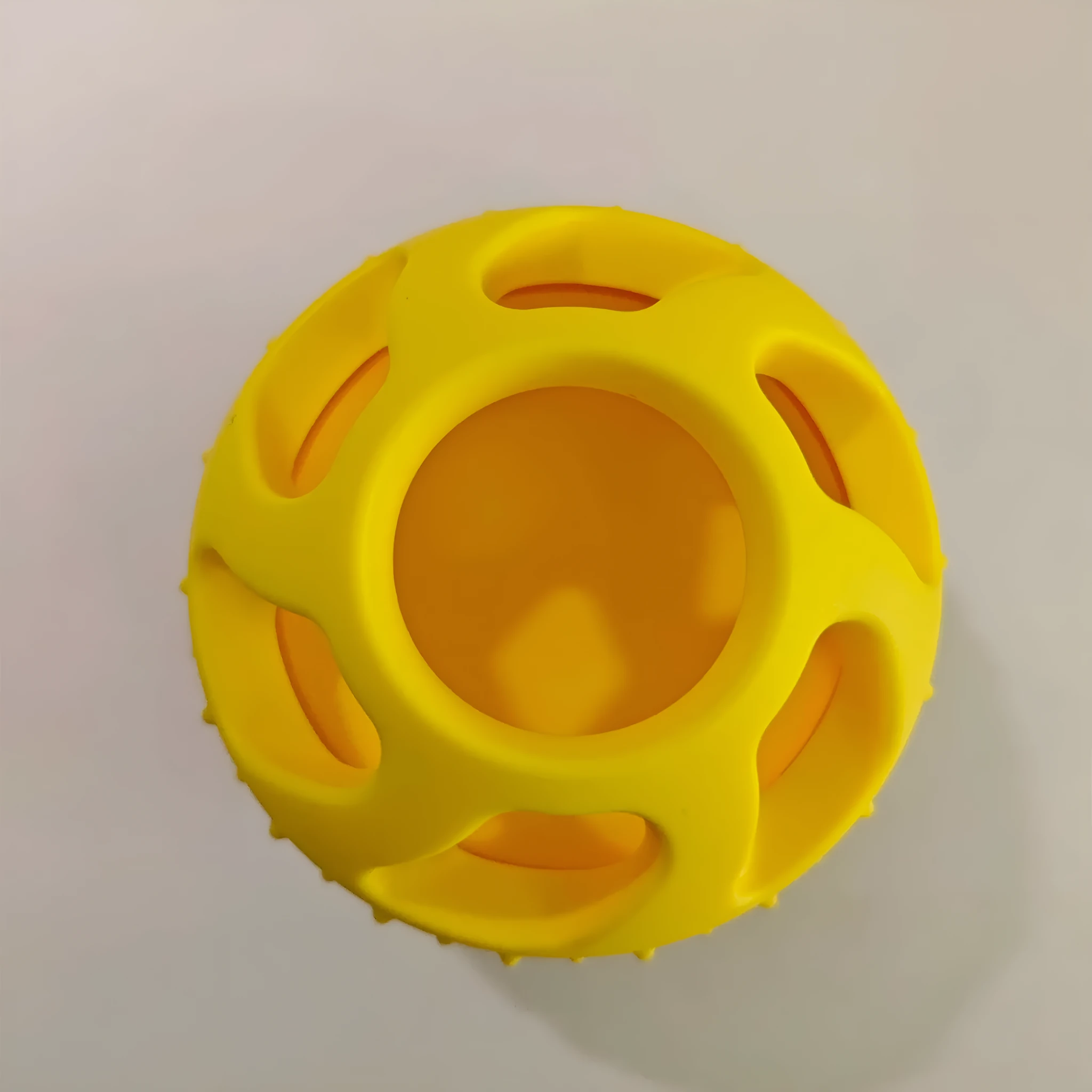 Yellow silicone pet slow feeder ball with snack mould for dogs and cats