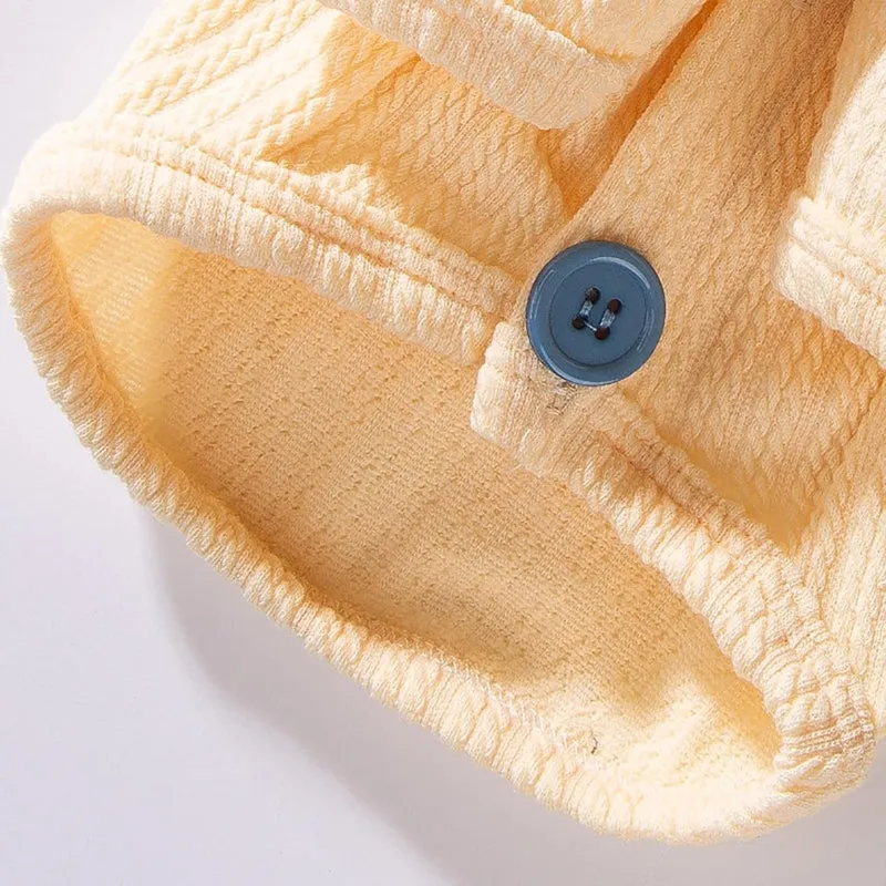 Yellow colour-block knit dog coat with bow tie collar on a small dog, suitable for autumn winter wear