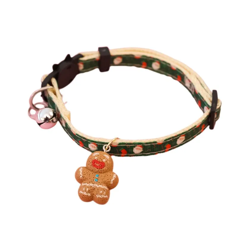 Christmas pet collar with bow tie, bell, and adjustable strap featuring Santa Claus and tree patterns