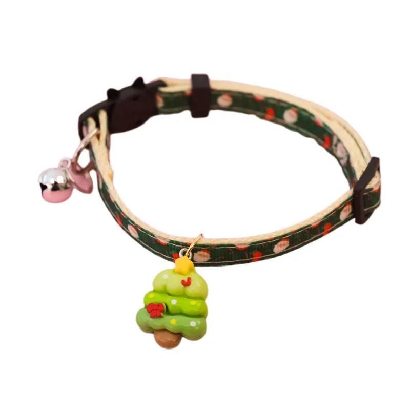 Christmas pet collar with bow tie, bell, and adjustable strap featuring Santa Claus and tree patterns