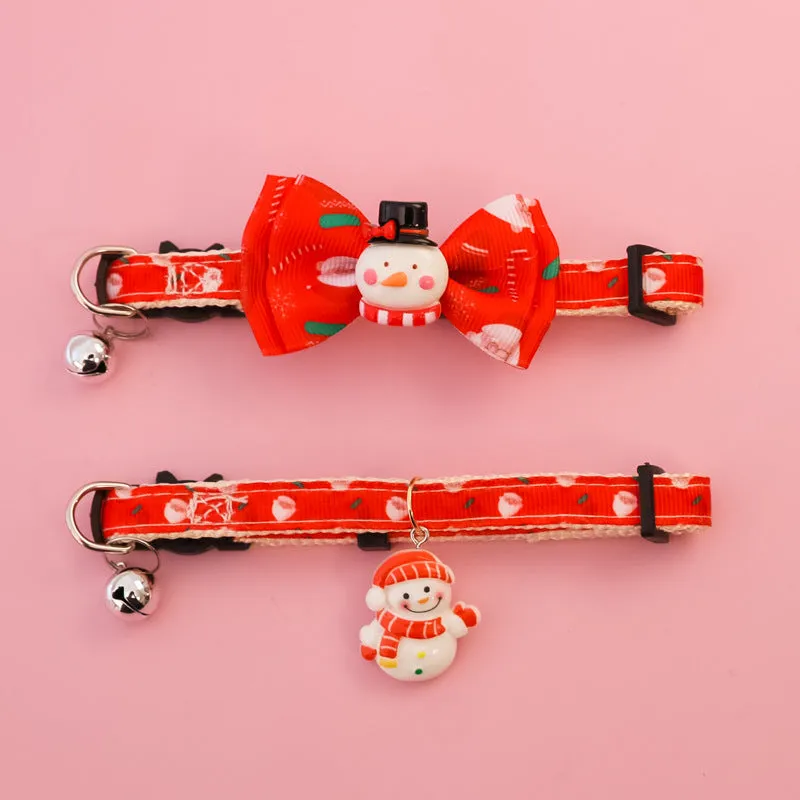 Christmas pet collar with bow tie, bell, and adjustable strap featuring Santa Claus and tree patterns