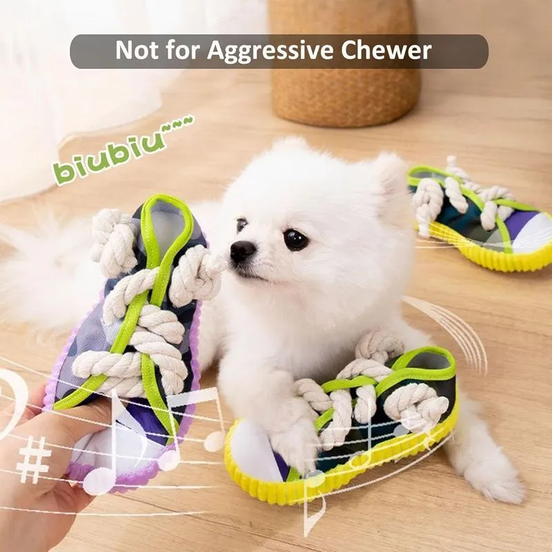 Grey and white dog toy slipper with black laces, blue sole, and a bell on the side