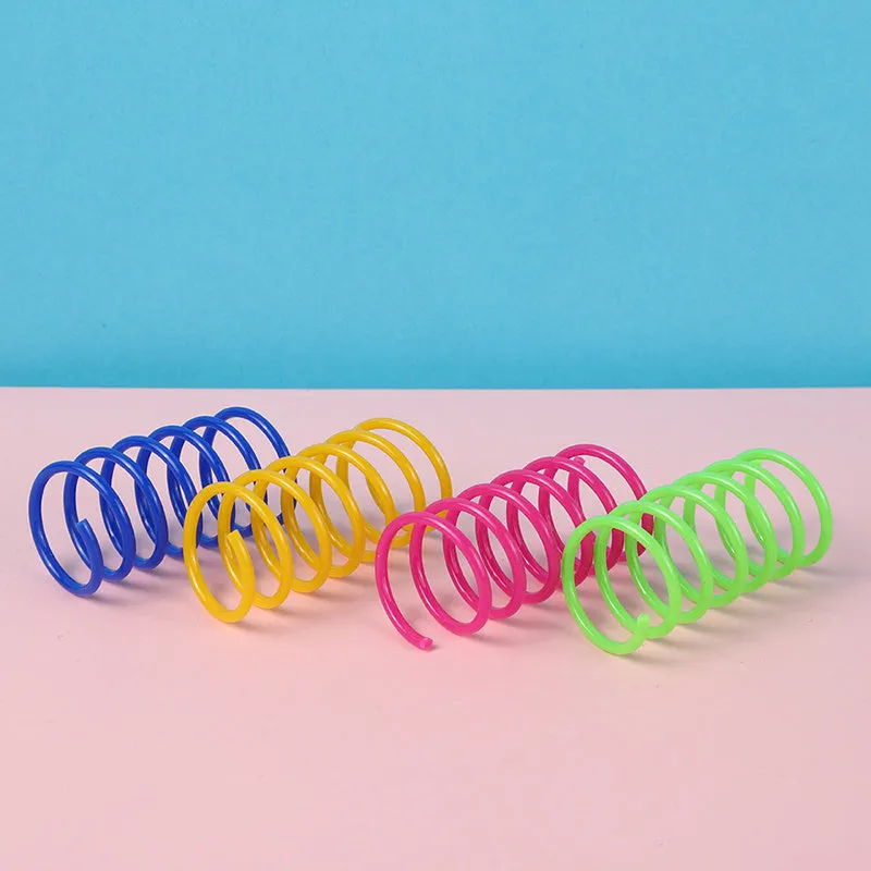 Colourful plastic coil spring cat toys shown in a mixed group, each measuring 5.5 cm long.