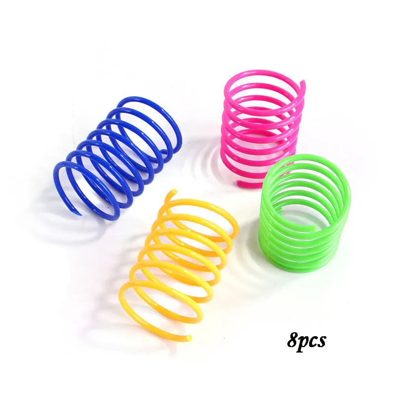 Colourful plastic coil spring cat toys shown in a mixed group, each measuring 5.5 cm long.