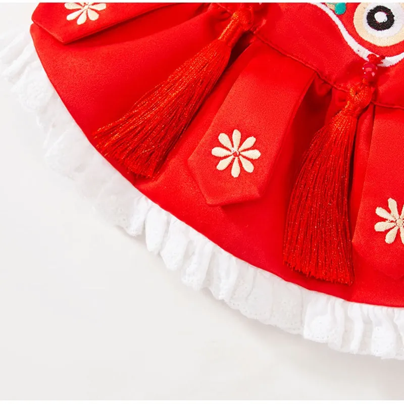 Red lion dance pet costume with embroidery and tassels on a dog