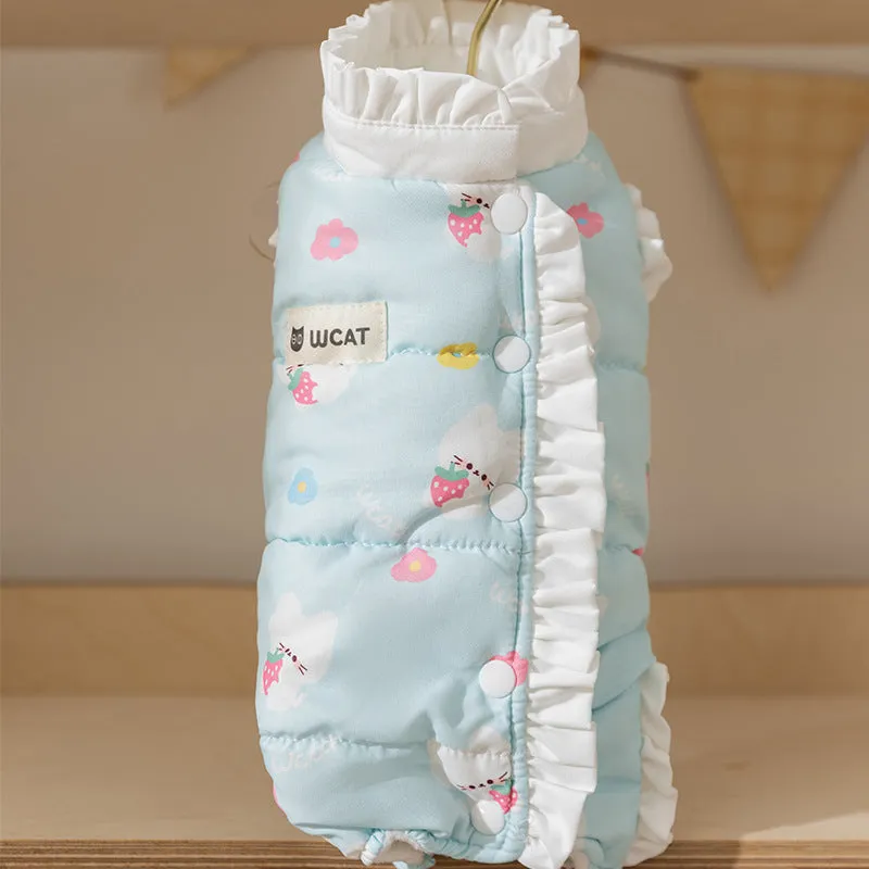 Small dog wearing cream fleece jumpsuit with bear pattern and white ruffles