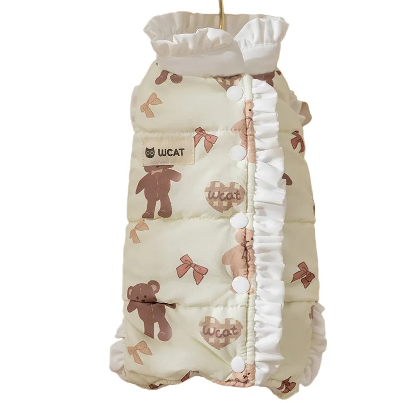Small dog wearing cream fleece jumpsuit with bear pattern and white ruffles