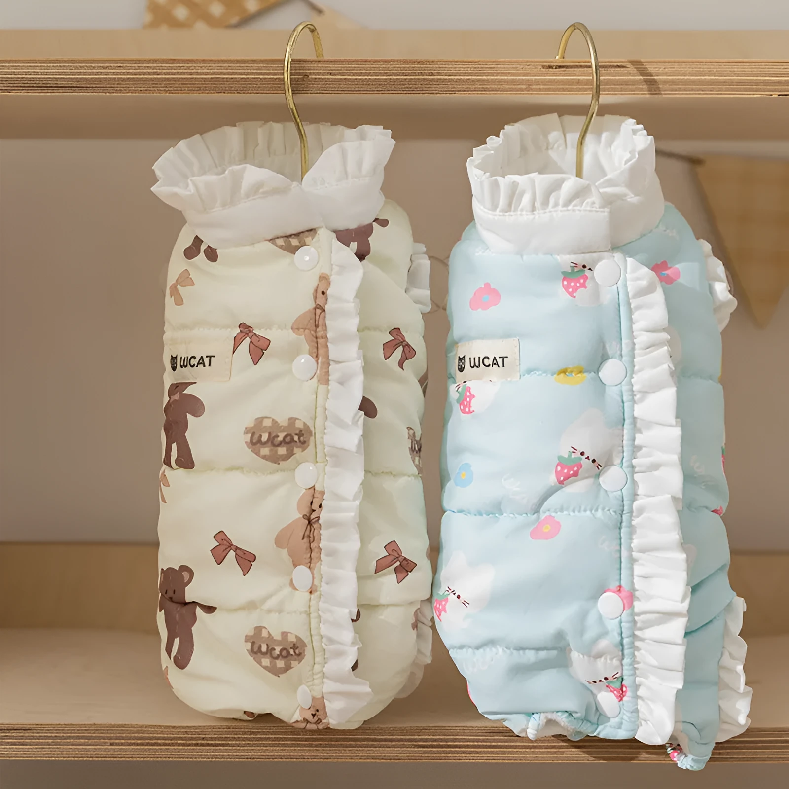 Small dog wearing cream fleece jumpsuit with bear pattern and white ruffles