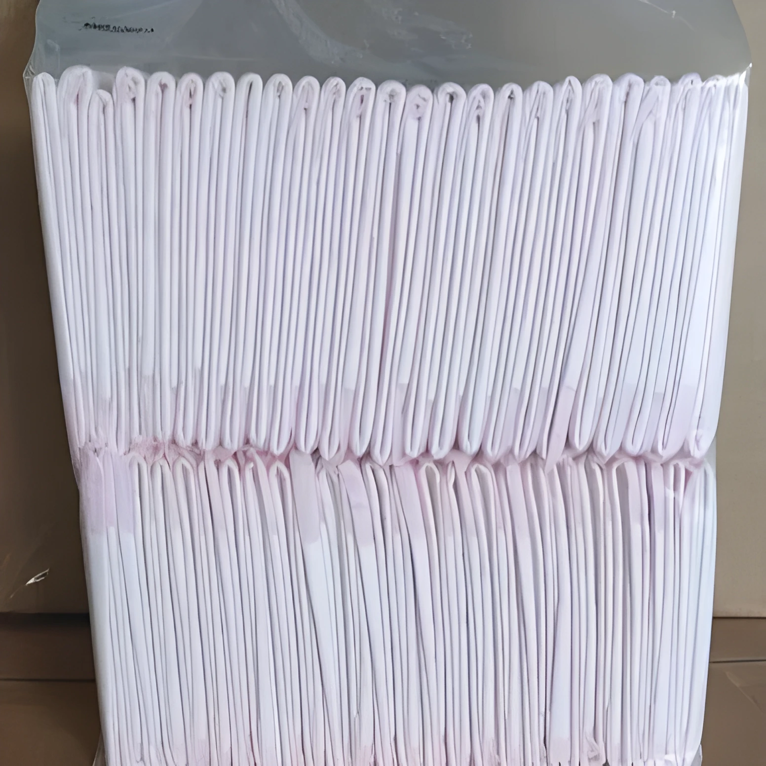 Large 60x60cm disposable pet urine pad for dog house training on a floor