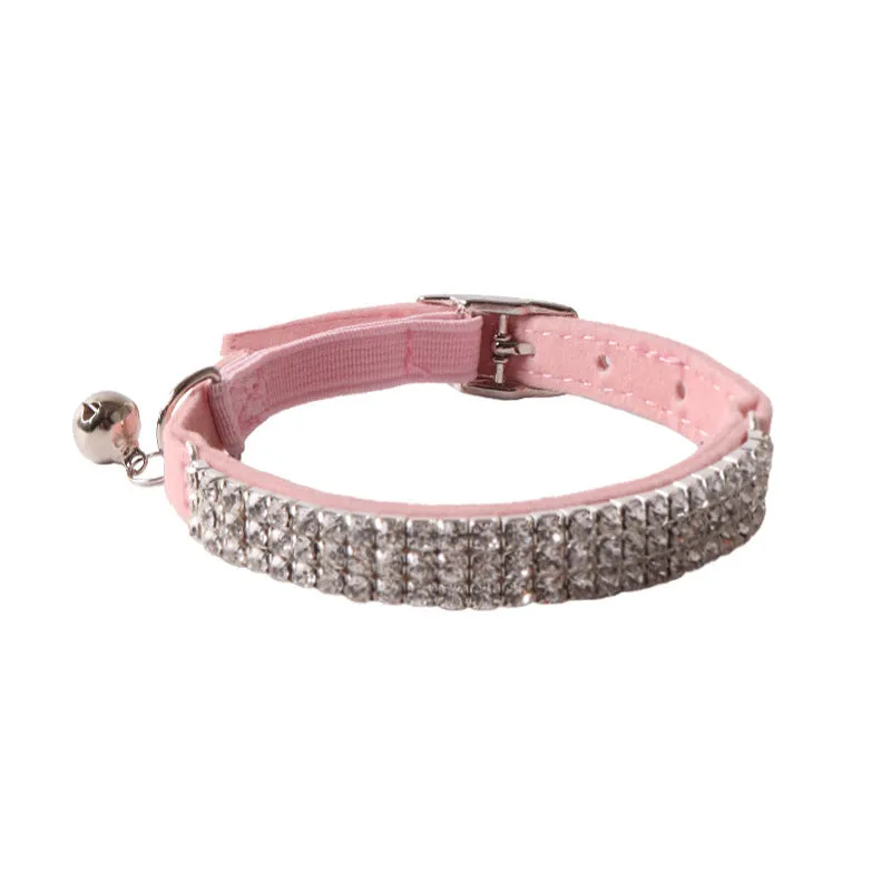 Pink flannel cat collar with elastic buckle and gang drill decoration on a textured flocked material.