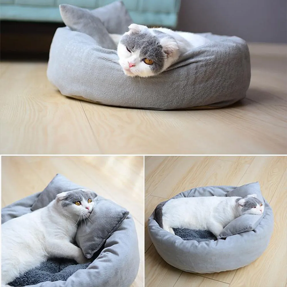 Grey round plush pet bed with raised edge and pillow, shown on a non-slip base.