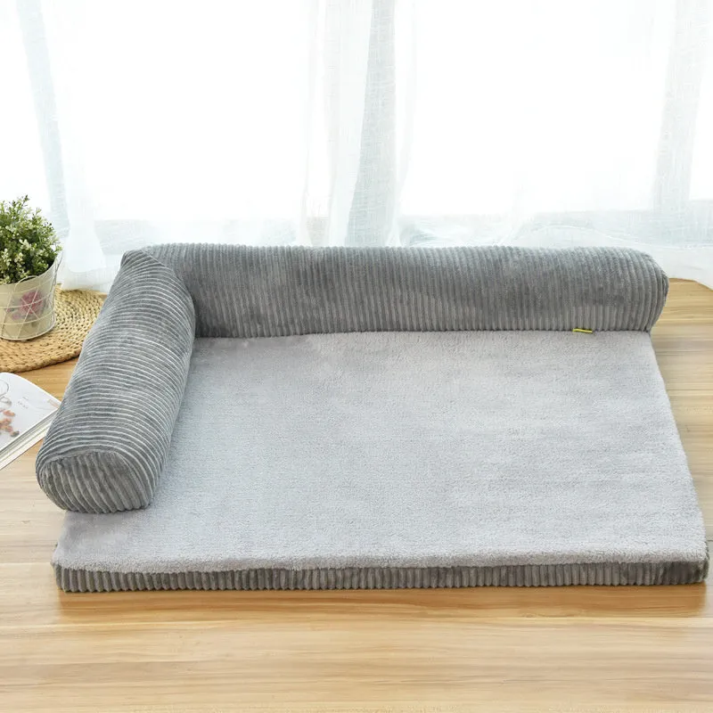 Corduroy dog sofa bed with bolster sides on a wooden floor, showing grey colour option in large size.