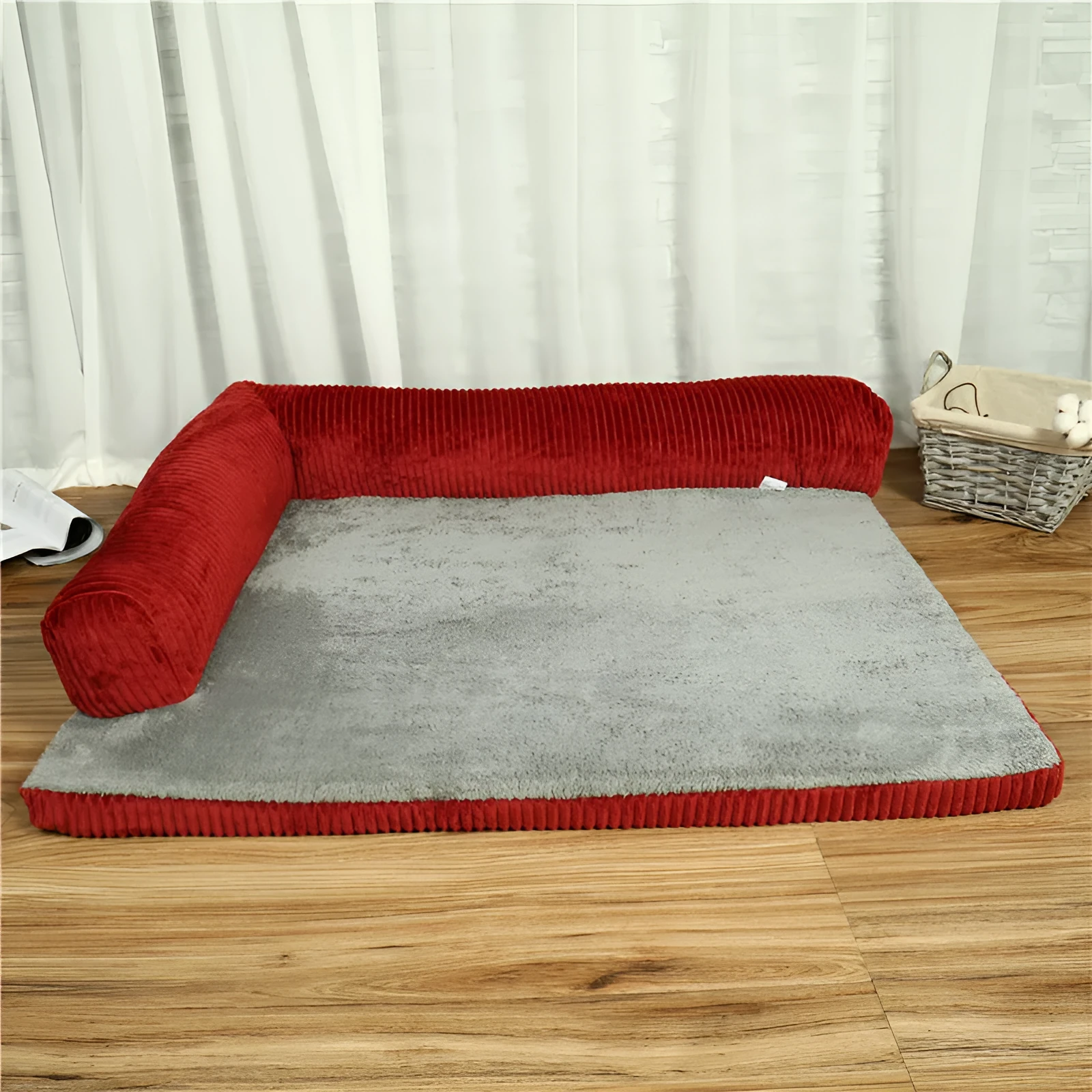 Corduroy dog sofa bed with bolster sides on a wooden floor, showing grey colour option in large size.