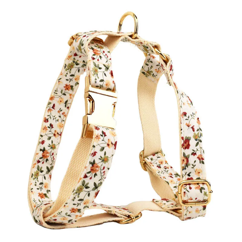 Small white flower pattern dog collar set with matching leash, vest, and bow on a mannequin.