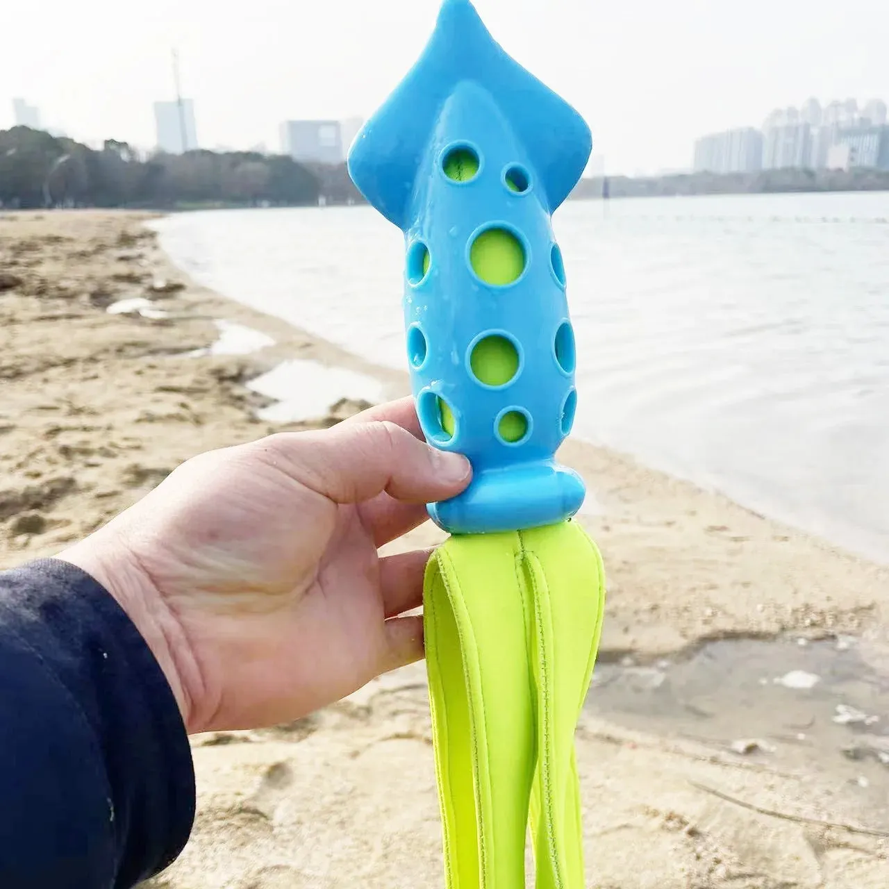 Blue cuttlefish-shaped dog chew toy with textured surface and squeaker for teeth cleaning