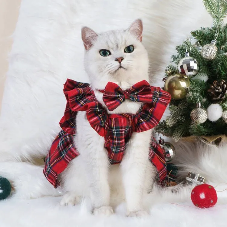 Red tartan Christmas skirt with bow tie and head flower on a dog, showing universal pet festive clothing.