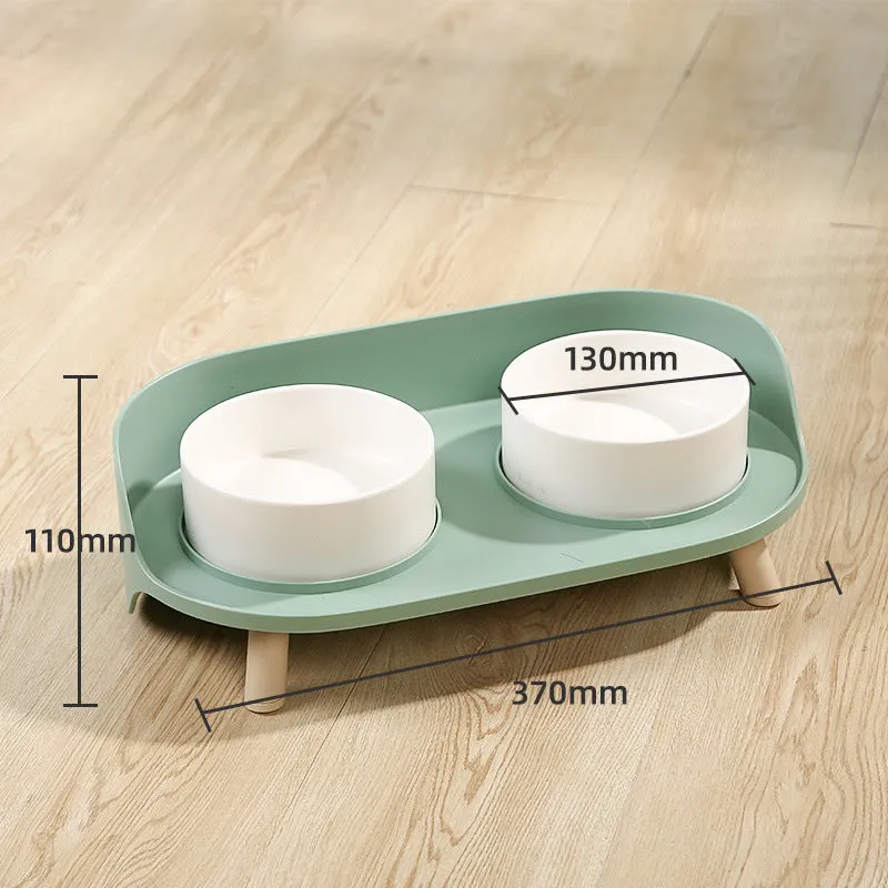 Green and white adjustable tilted pet feeding bowl with dual food and water compartments for cats and dogs