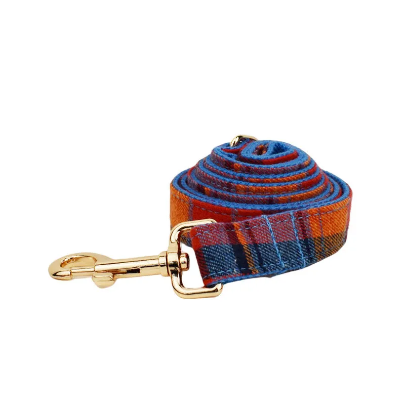 Gentleman-style dog collar, leash, bow, and vest four-piece cloth pet accessory set laid out flat.