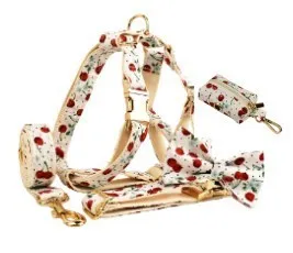 Red cherry print cloth dog collar with light gold release buckle, part of a five-piece pet accessory set.