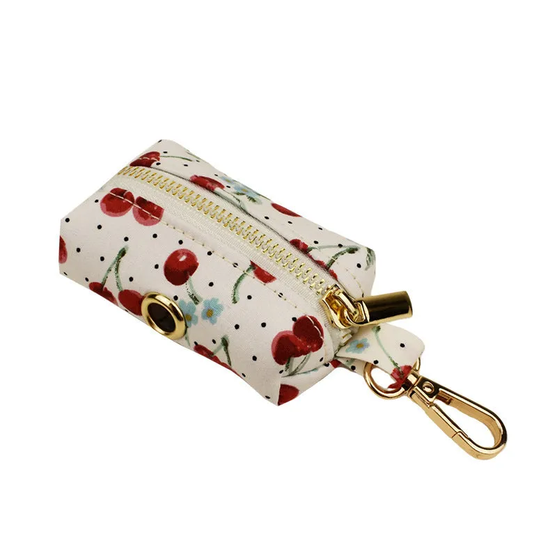 Red cherry print cloth dog collar with light gold release buckle, part of a five-piece pet accessory set.