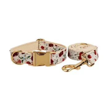 Red cherry print cloth dog collar with light gold release buckle, part of a five-piece pet accessory set.