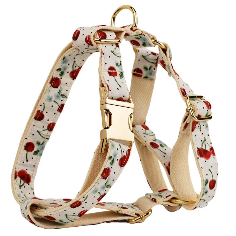 Red cherry print cloth dog collar with light gold release buckle, part of a five-piece pet accessory set.