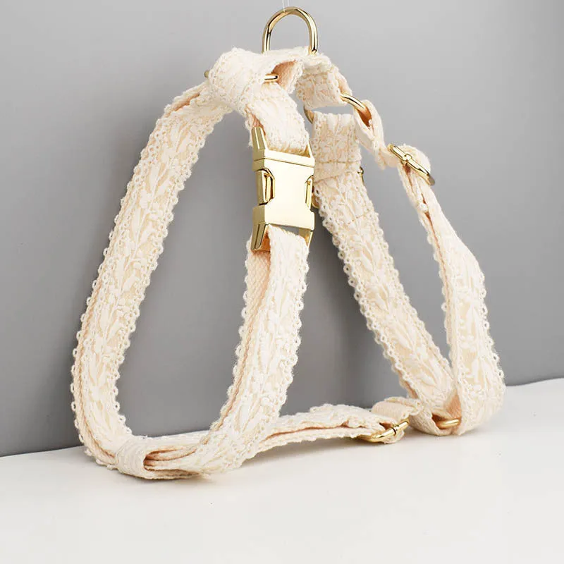 Four-piece dog wedding set with lace vest, matching collar, flower headband, and leash on white background