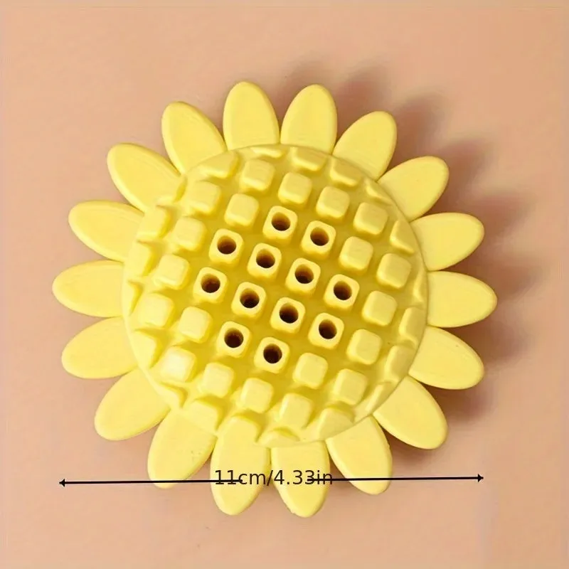 Yellow sunflower-shaped rubber dog chew toy with squeaker