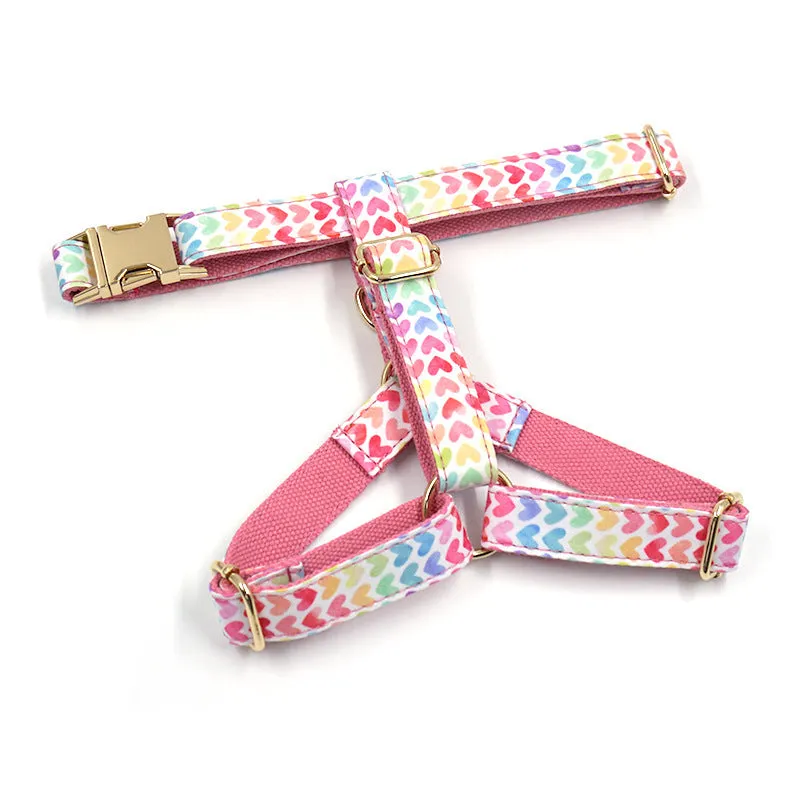 Pink dog harness with gold buckle and heart-shaped stone decoration on a chest and back strap