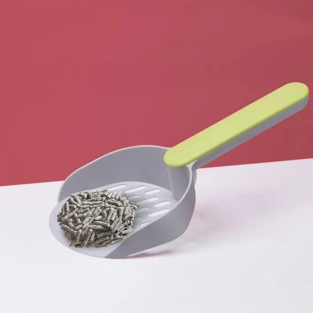 Blue plastic cat litter shovel scoop for cleaning litter boxes, shown next to a litter tray.