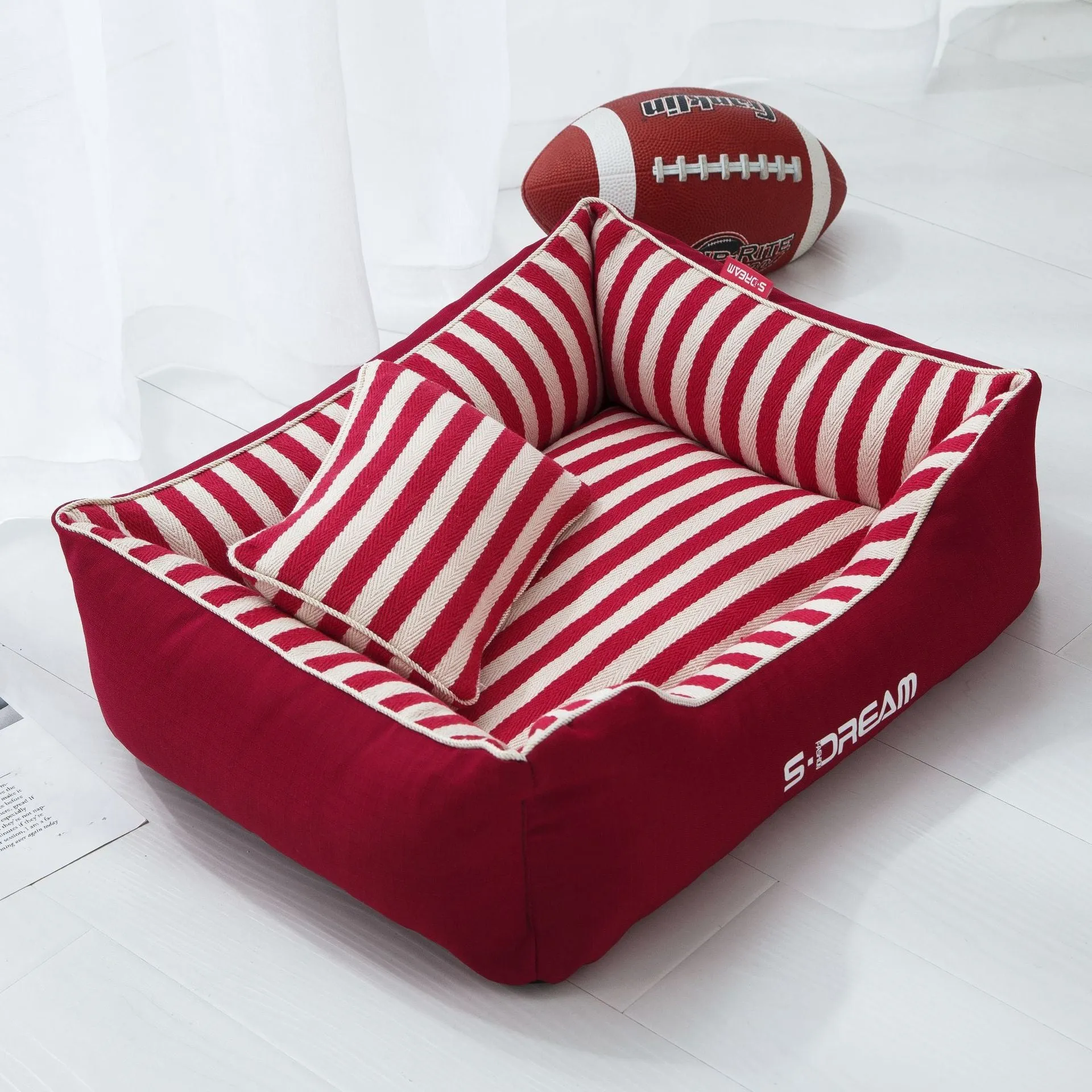 Navy stripes removable dog kennel mat and matching mini pillow set on a wooden floor