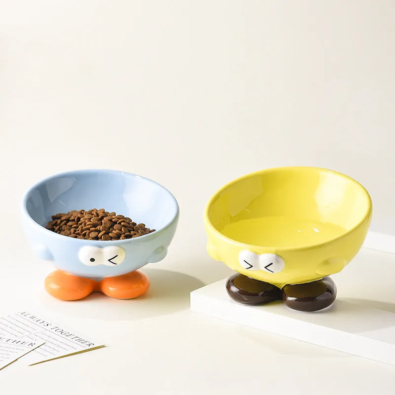 Oblique ceramic pet bowl with cute expression pattern, tall design for cervical spine protection