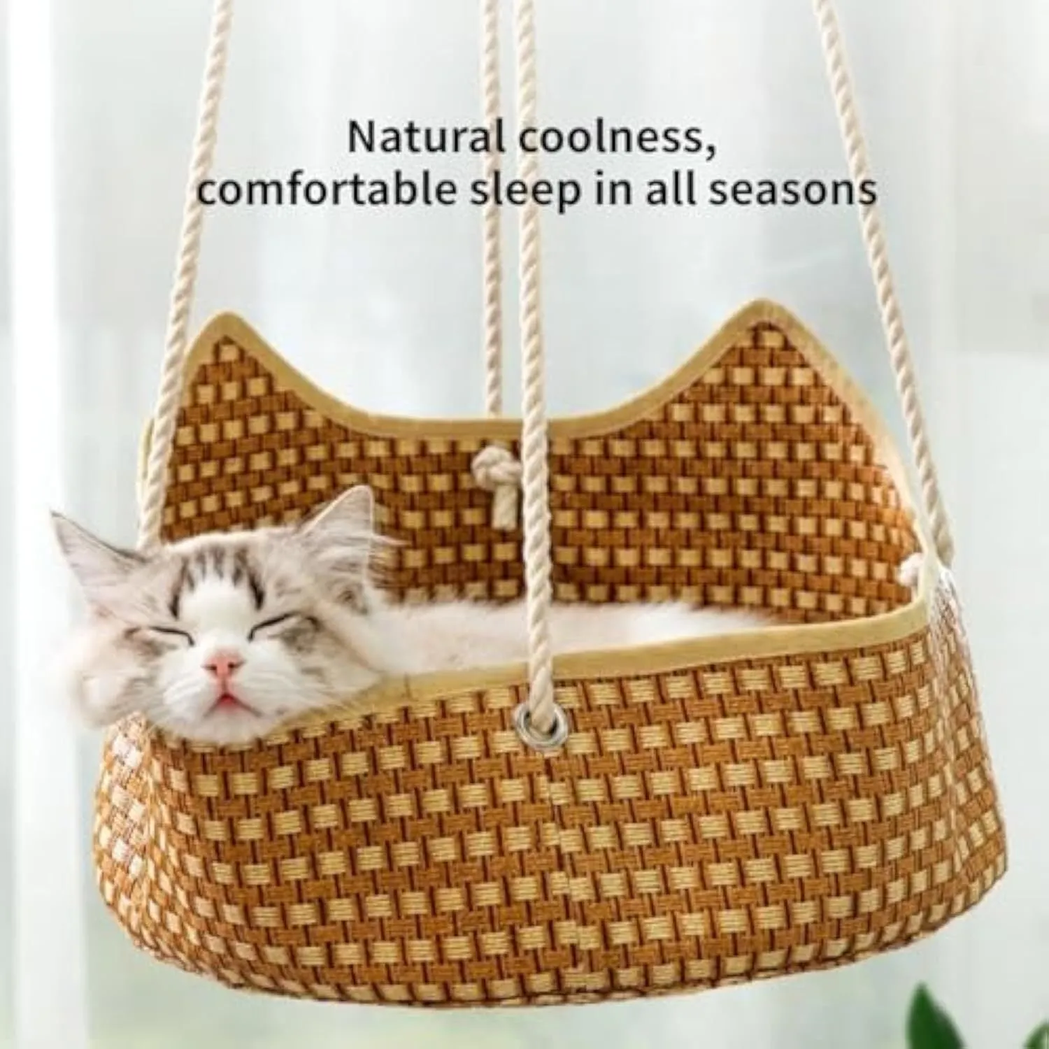 Green rattan cat hammock with cotton ropes and metal hooks, shown hanging.