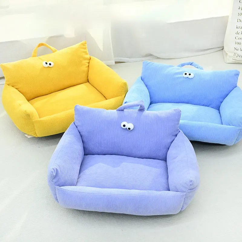 Blue cartoon big eye pet sofa kennel bed for small dog on a wooden floor.