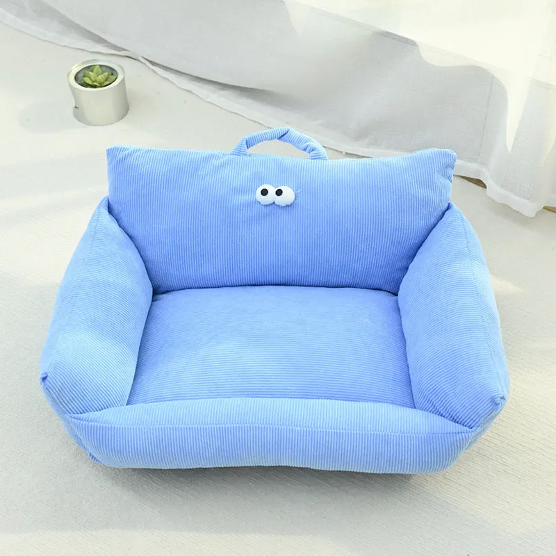 Blue cartoon big eye pet sofa kennel bed for small dog on a wooden floor.