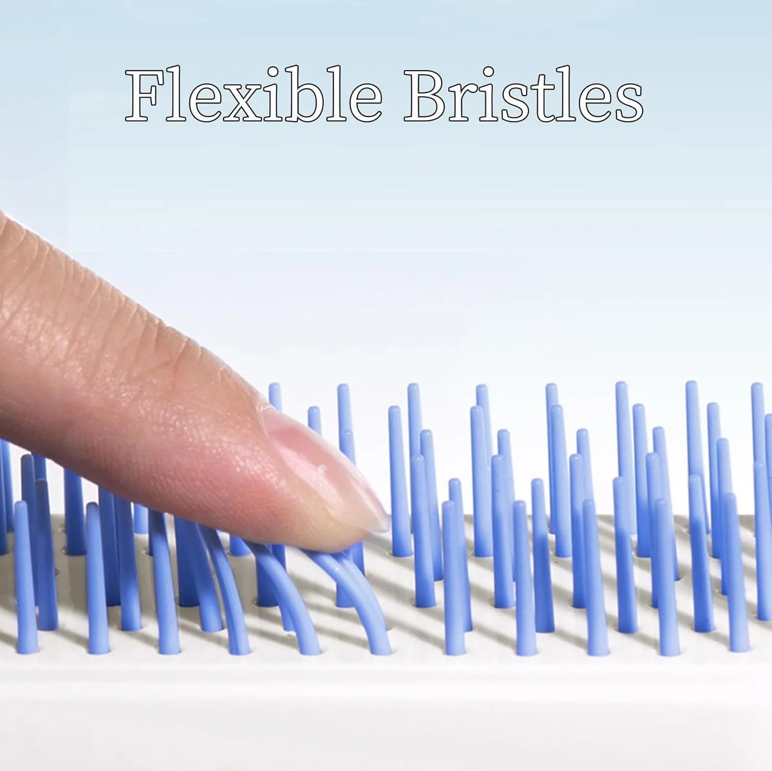Blue, pink, and white dual-sided soft bristle brush for grooming small dogs