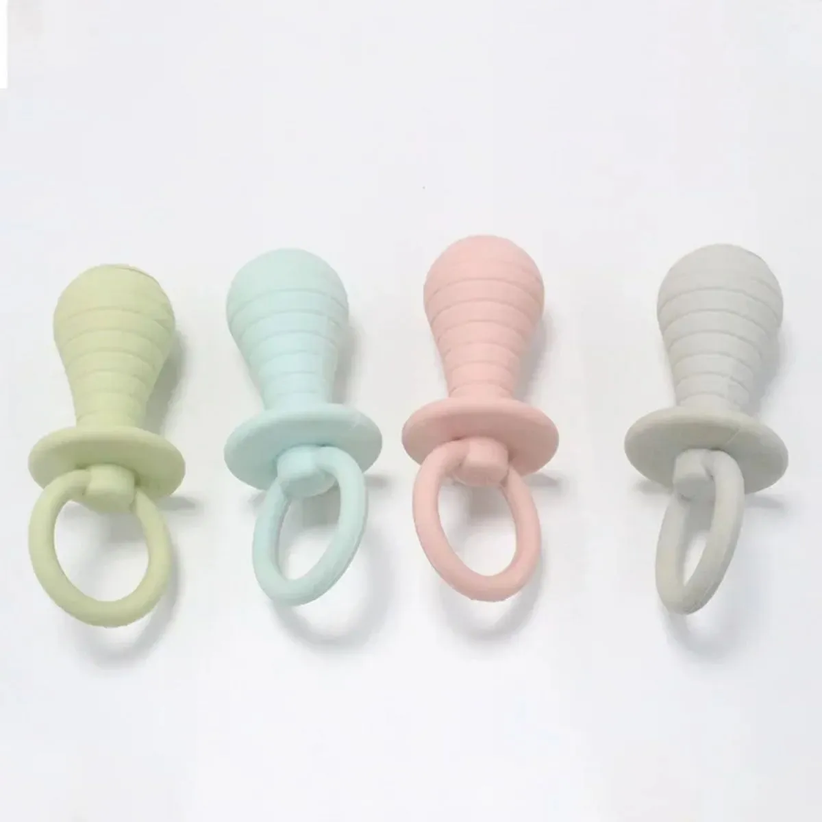 Four coloured pet pacifier chew toys with squeaker for puppies and kittens