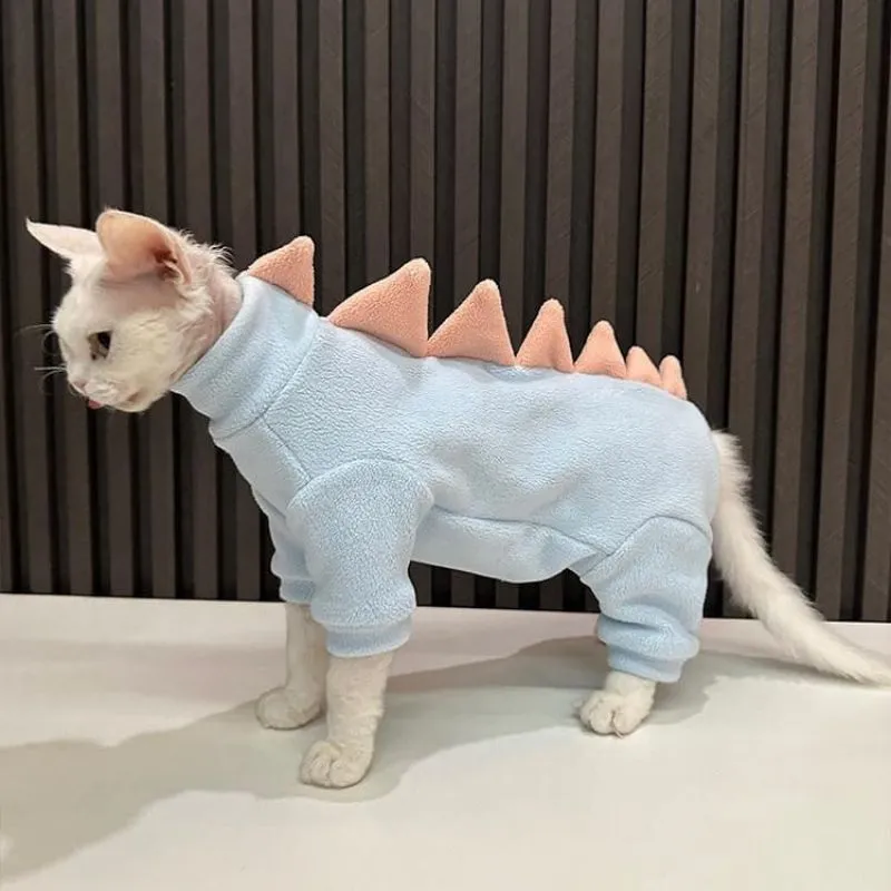 Sphynx cat wearing dinosaur costume with tail and spikes