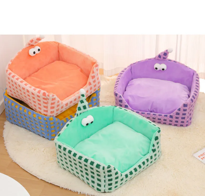 Green triangular hat-shaped pet sleeping nest for cats on a floor, showing its thick sponge construction.