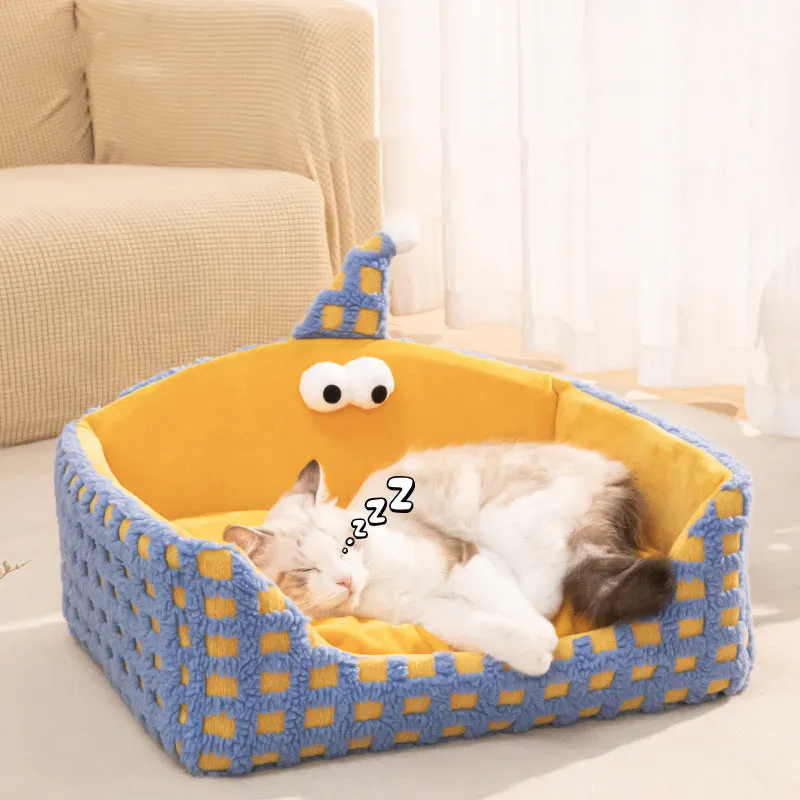 Green triangular hat-shaped pet sleeping nest for cats on a floor, showing its thick sponge construction.