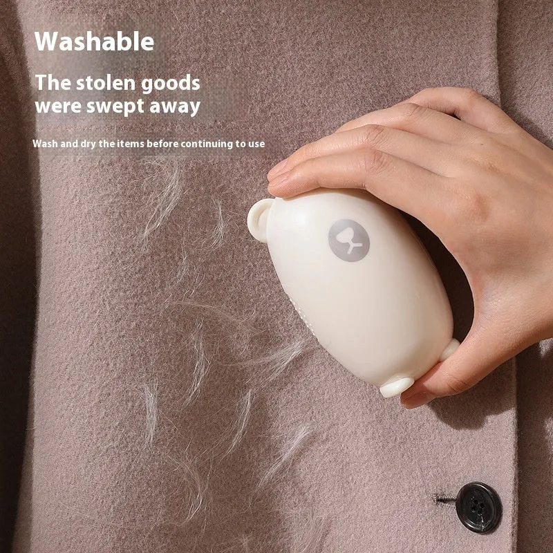 White washable lint roller with removable sticky head for removing hair and dust from fabrics.