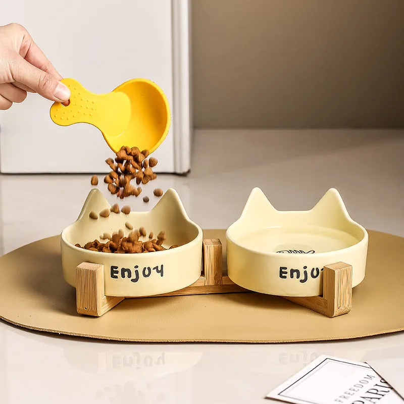 Porcelain cat food bowl with wooden anti-tumble frame in cat paw design