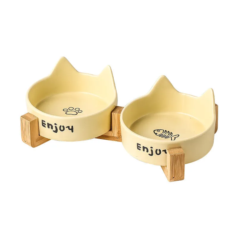 Porcelain cat food bowl with wooden anti-tumble frame in cat paw design