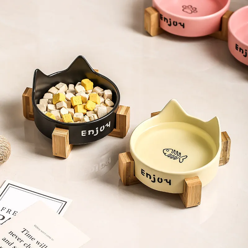 Porcelain cat food bowl with wooden anti-tumble frame in cat paw design