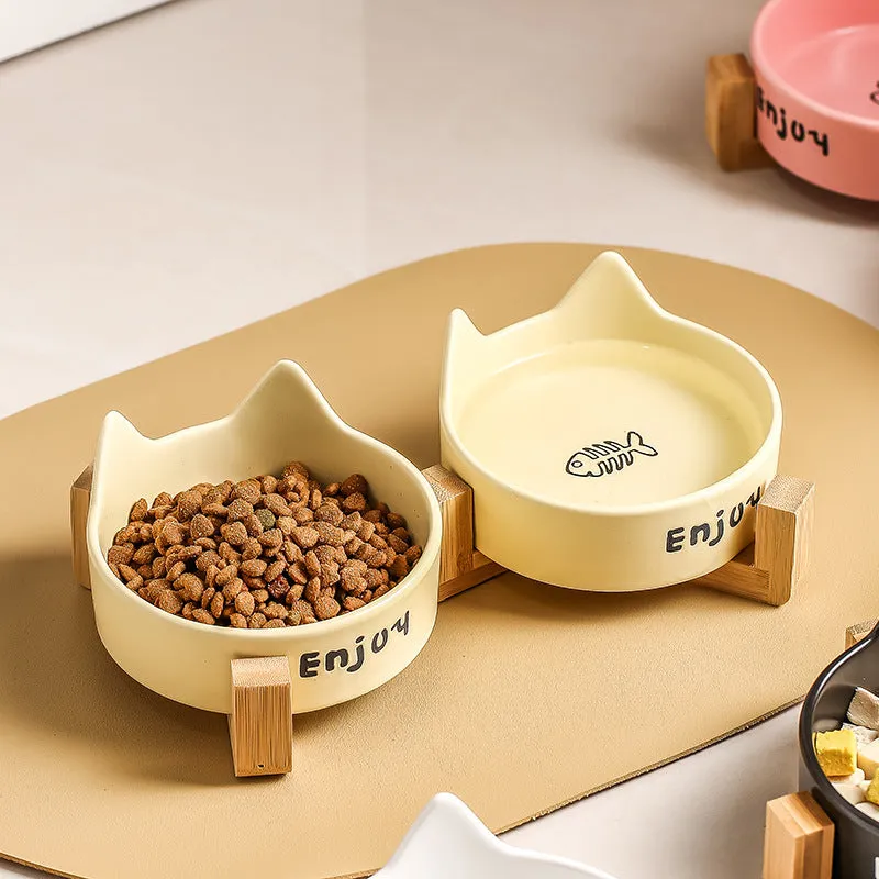 Porcelain cat food bowl with wooden anti-tumble frame in cat paw design