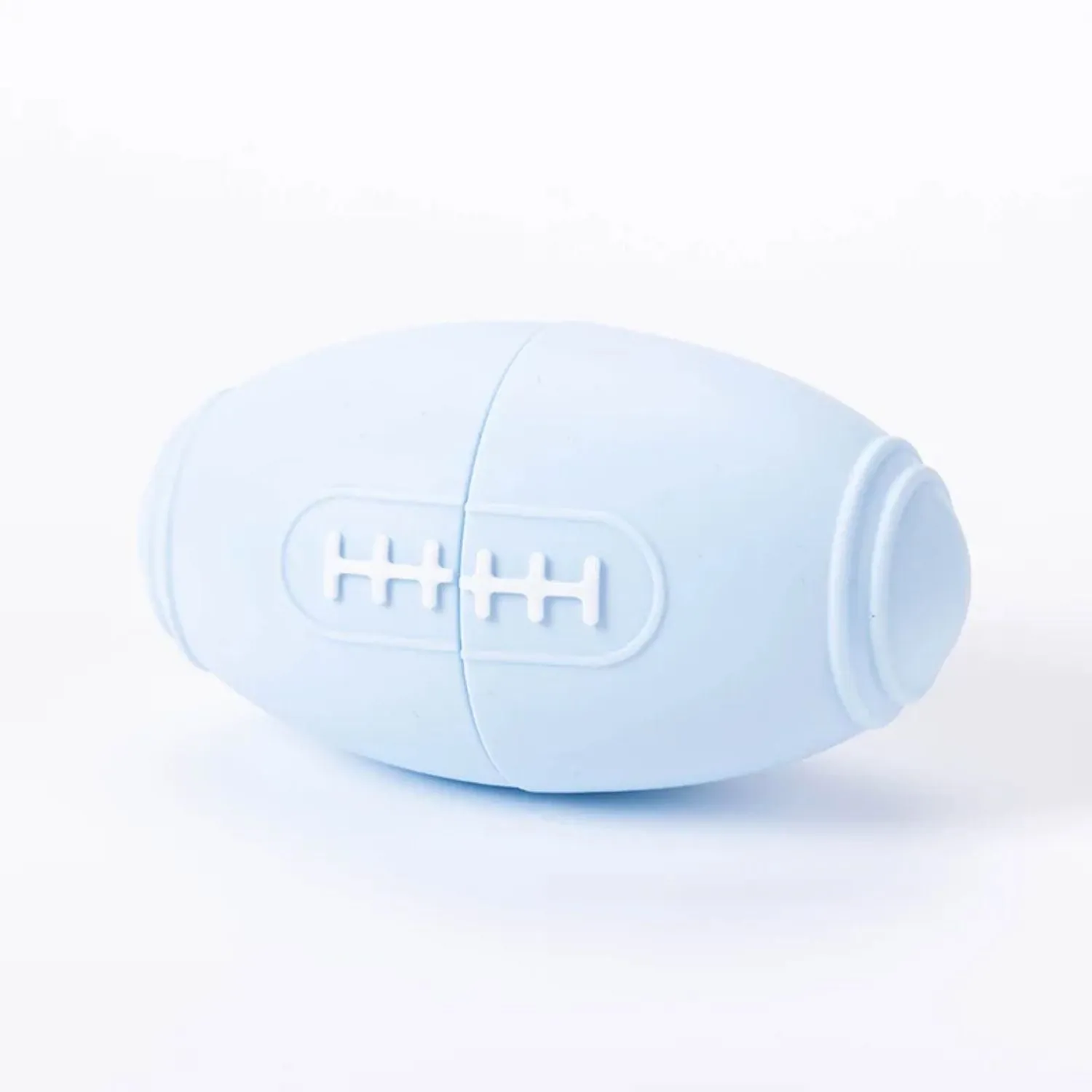 Coloured silicone rugby ball dog chew toy with treat-dispensing holes in blue, pink, purple options