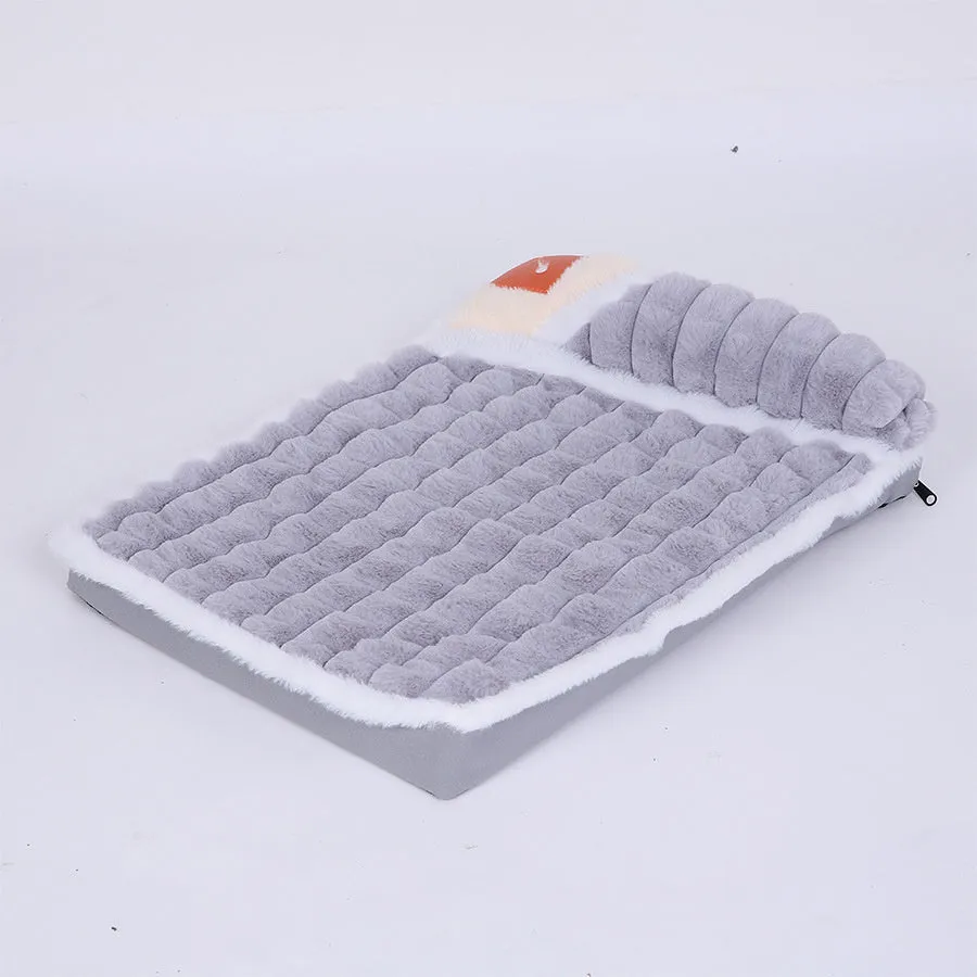 Large rectangular dog bed mat with a removable cover in a grey colour on a wooden floor.
